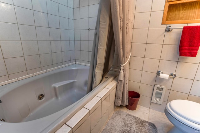 bathroom featuring tile walls, toilet, and shower / tub combo with curtain