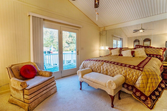 bedroom with access to exterior, multiple windows, lofted ceiling with beams, and carpet floors