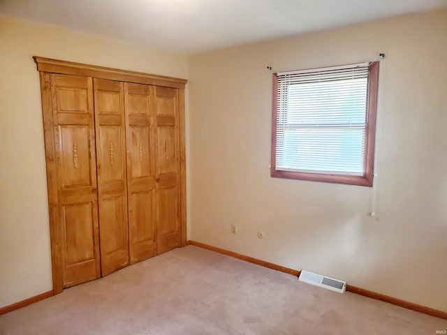 unfurnished bedroom with light carpet