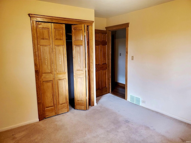 unfurnished bedroom featuring light colored carpet