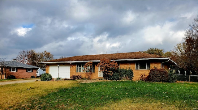 ranch-style home with a front lawn and a garage