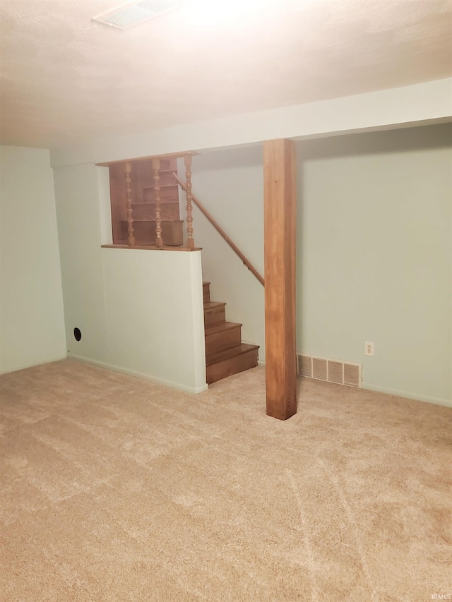 basement featuring light colored carpet