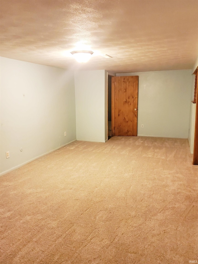 carpeted spare room with a textured ceiling