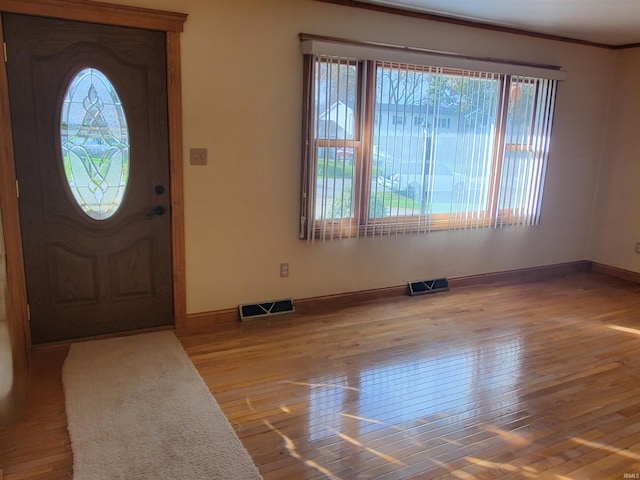 entrance foyer with plenty of natural light and light hardwood / wood-style flooring