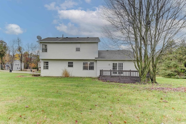 back of property with a yard, a storage shed, and a wooden deck