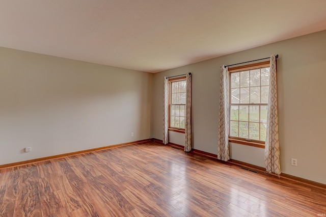 unfurnished room with hardwood / wood-style floors