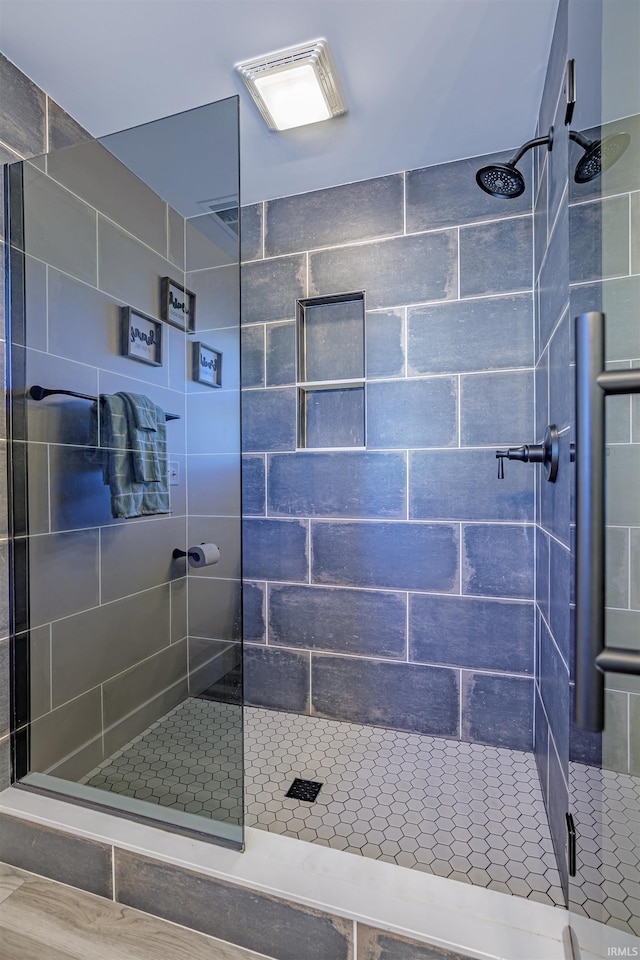 bathroom with a shower with shower door