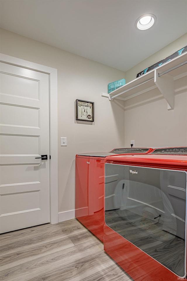 laundry area with light wood-type flooring and independent washer and dryer