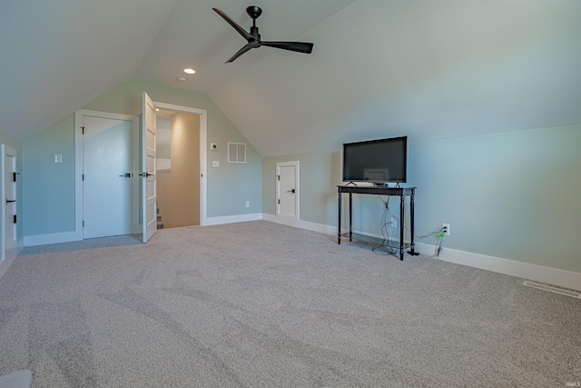 additional living space with vaulted ceiling, light colored carpet, and ceiling fan