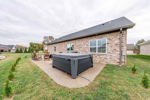 back of house with a lawn and a patio