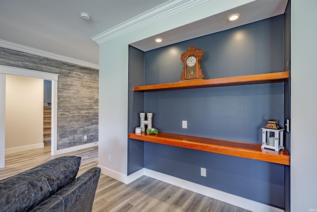 bar featuring ornamental molding and hardwood / wood-style flooring