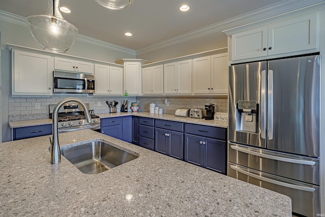 kitchen with white cabinets, appliances with stainless steel finishes, ornamental molding, and pendant lighting