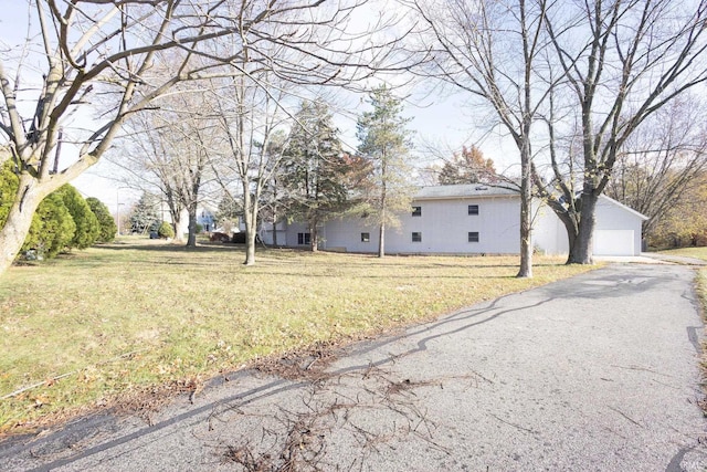 exterior space with a garage and a yard