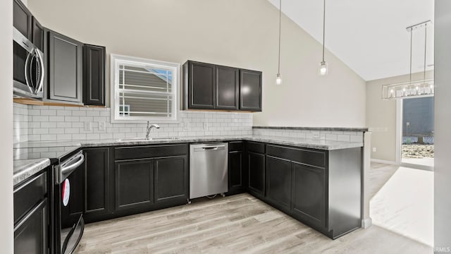 kitchen featuring light stone countertops, pendant lighting, tasteful backsplash, appliances with stainless steel finishes, and sink