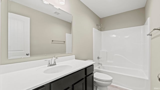 full bathroom with  shower combination, vanity, and toilet