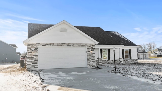 view of front of property with central AC unit and a garage