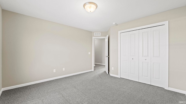 unfurnished bedroom featuring carpet flooring and a closet