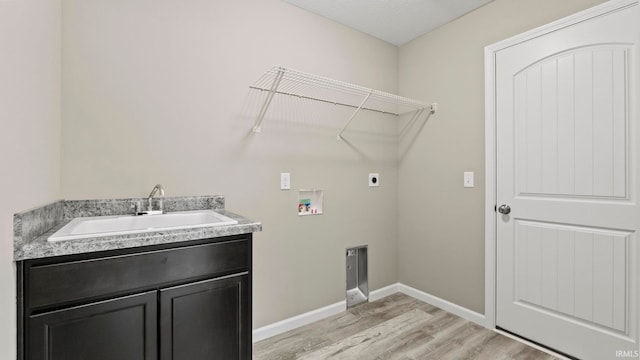 laundry room featuring sink, washer hookup, electric dryer hookup, cabinets, and light wood-type flooring