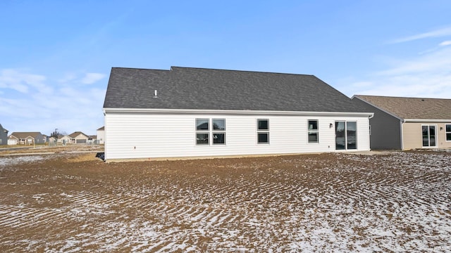 view of snow covered rear of property