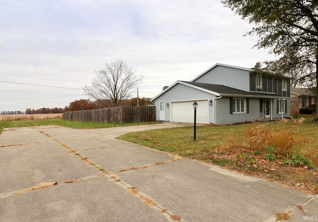 view of home's exterior with a garage and a yard