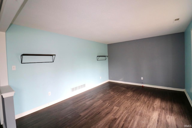 unfurnished room featuring dark wood-type flooring