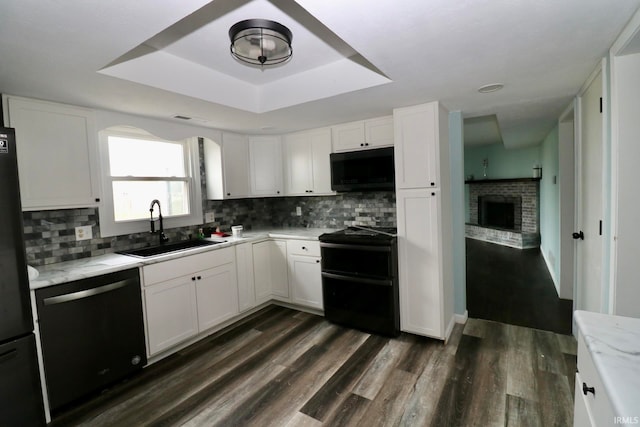 kitchen with white cabinetry, black appliances, and dark hardwood / wood-style floors