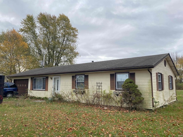 single story home with a front lawn and a garage