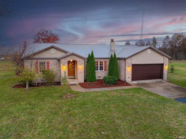 single story home with a lawn and a garage