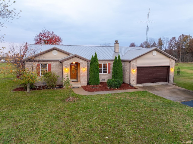 single story home featuring a garage and a front lawn