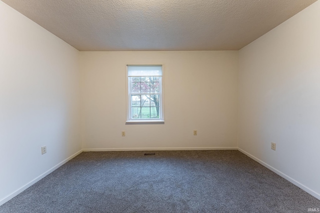 carpeted spare room featuring a textured ceiling