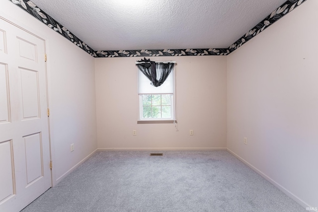 spare room with carpet floors and a textured ceiling