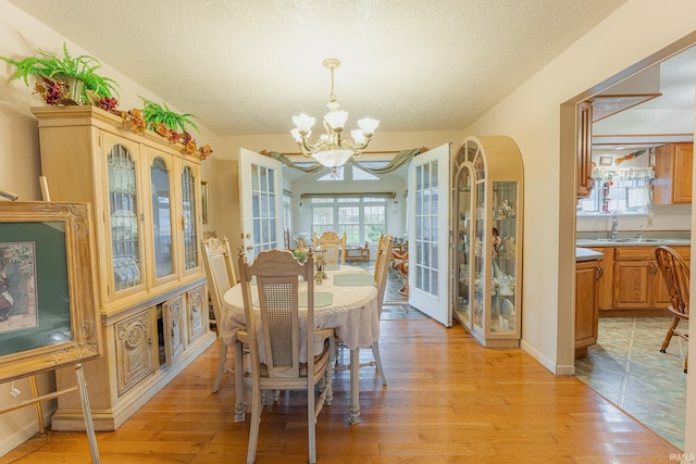 dining area featuring a wealth of natural light, a chandelier, and light hardwood / wood-style floors