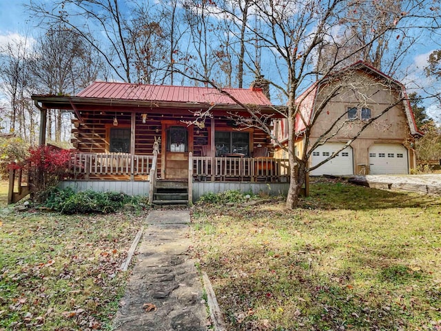 log cabin with a garage, a porch, and a front yard