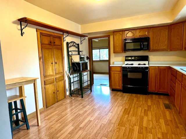 kitchen featuring black appliances and light hardwood / wood-style floors