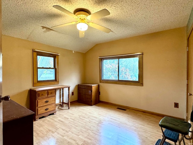 sitting room featuring a textured ceiling, light hardwood / wood-style flooring, lofted ceiling, and ceiling fan