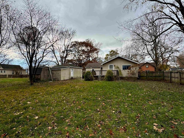 back of property featuring a yard and a storage shed