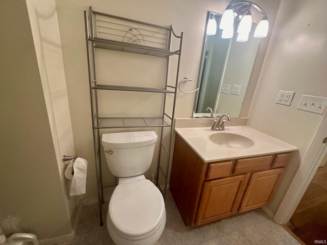 bathroom with vanity, tile patterned floors, and toilet