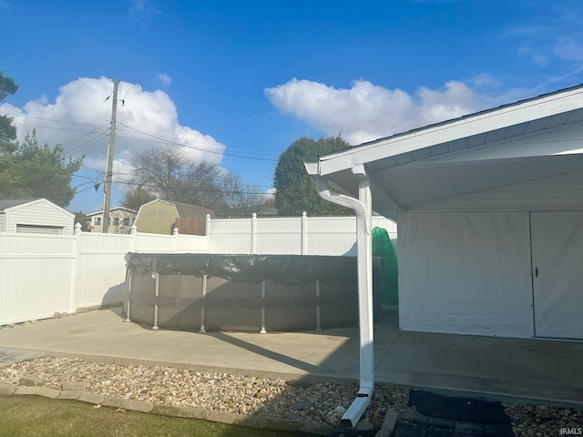 view of yard featuring a storage shed and a patio