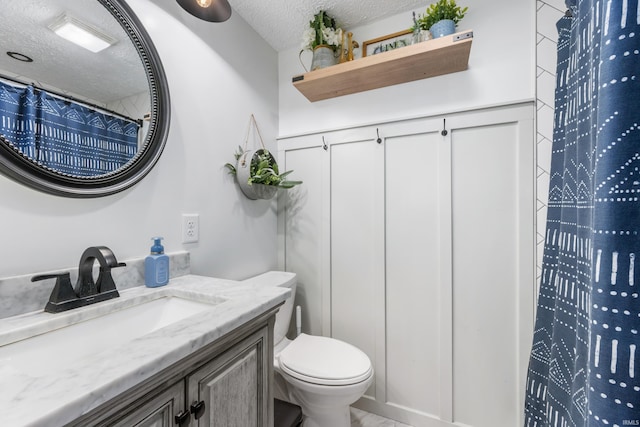 bathroom with curtained shower, vanity, a textured ceiling, and toilet