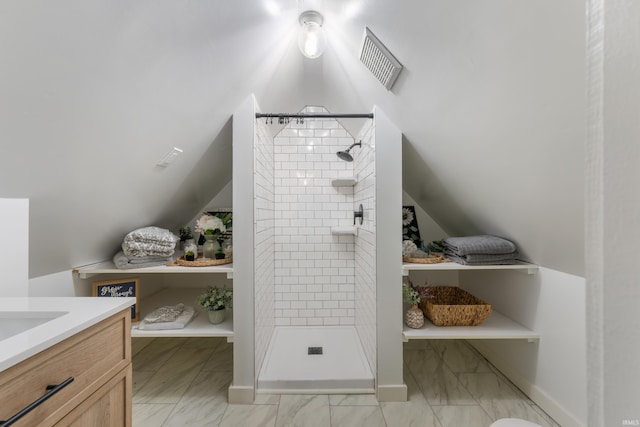 bathroom featuring vanity and a tile shower