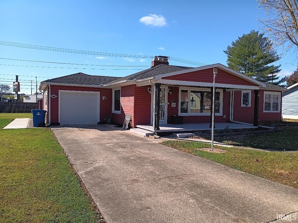 single story home featuring a front lawn and a garage