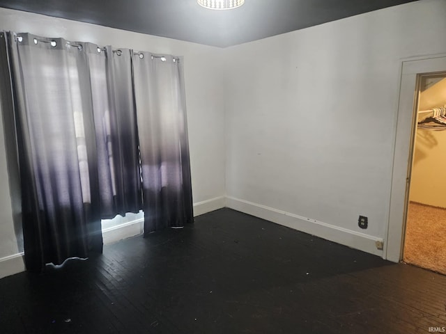 empty room featuring dark wood-type flooring