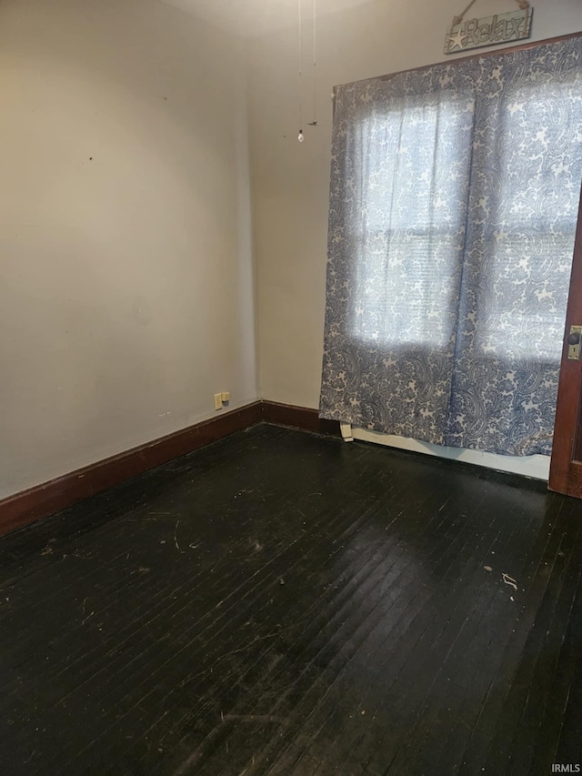 unfurnished room featuring dark wood-type flooring