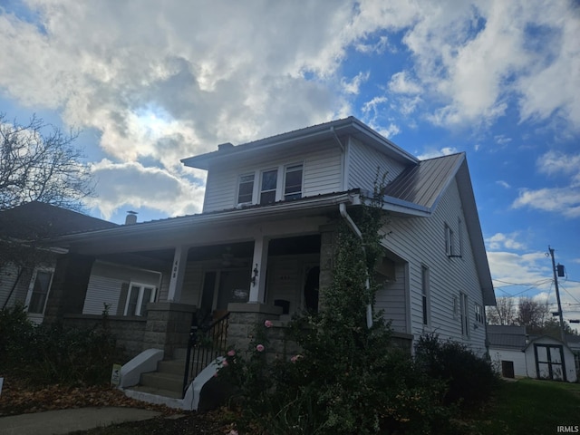 view of front facade with a shed and covered porch