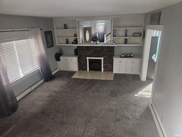 living room featuring a fireplace, a baseboard radiator, and dark carpet