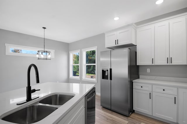 kitchen with stainless steel fridge, black dishwasher, sink, light hardwood / wood-style floors, and white cabinets