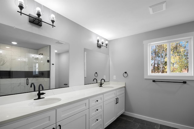 bathroom with tile patterned flooring, vanity, and a shower with shower door