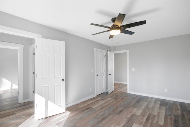 unfurnished room with hardwood / wood-style floors and ceiling fan