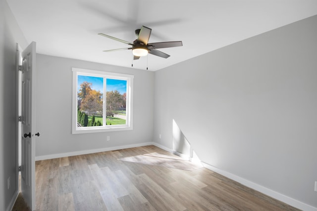 empty room featuring ceiling fan and light hardwood / wood-style flooring