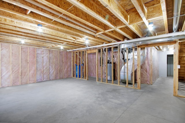 basement with water heater and heating unit